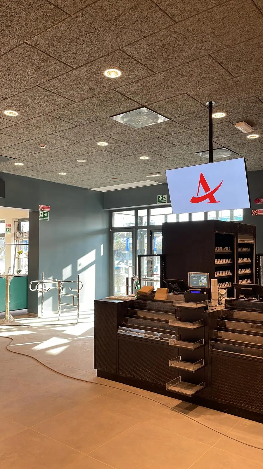 Autogrill checkout and coffee area with screen and turnstiles